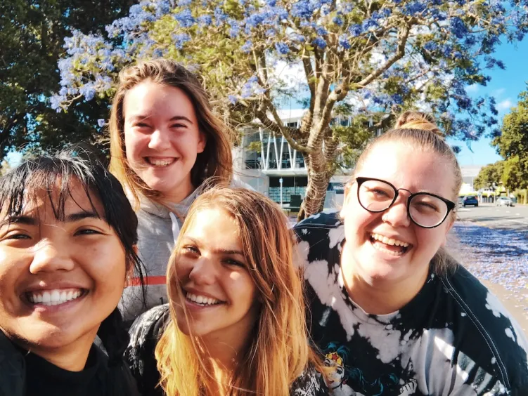 4 women looking at camera smiling