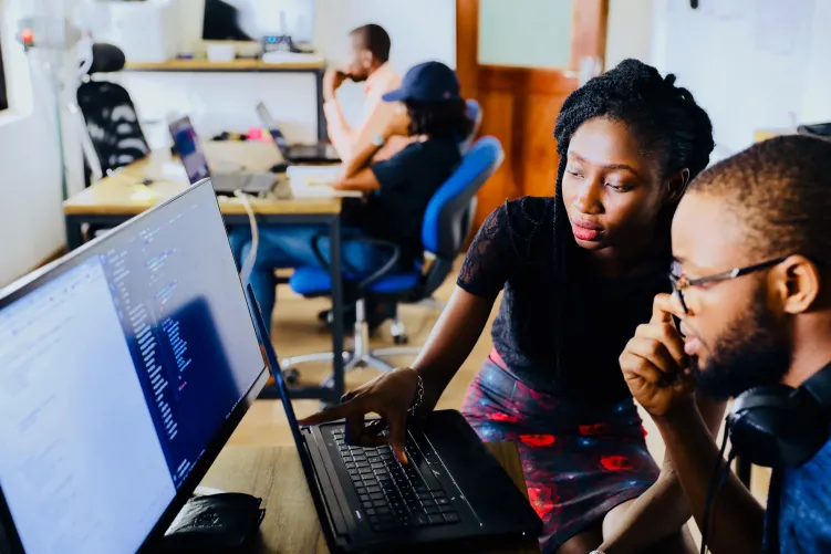 2 people looking at computer screen