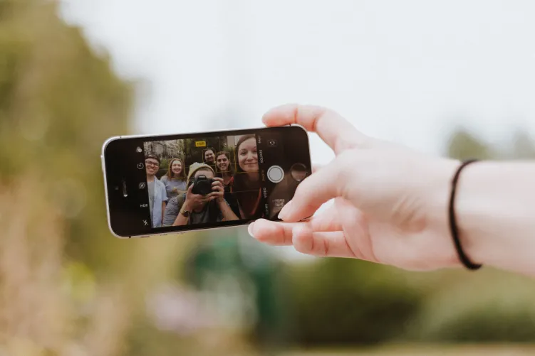 Picture of people taking a selfie on phone