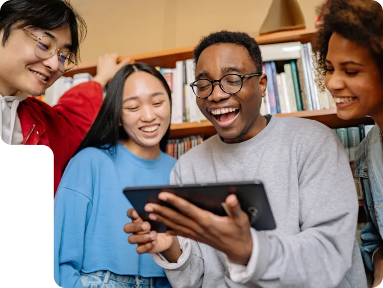 4 x people stood around a tablet in library