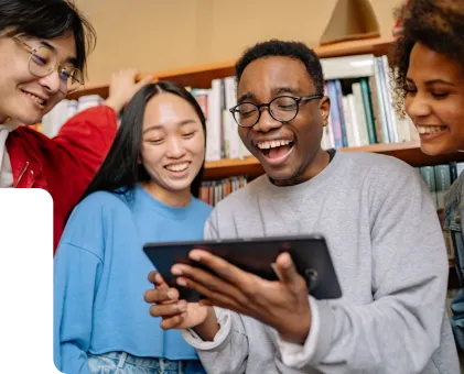 4 x people stood around a tablet in library